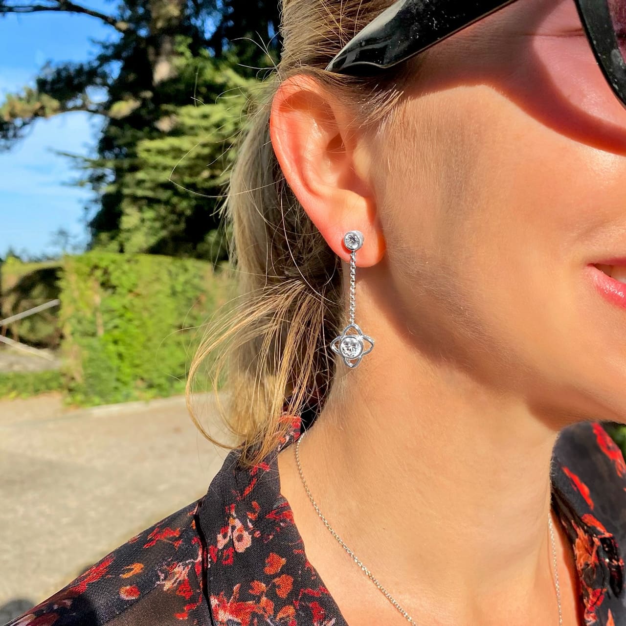 Frau trägt moderne Ohrringe aus Silber mit Steinen im Baummuseum Rapperswill