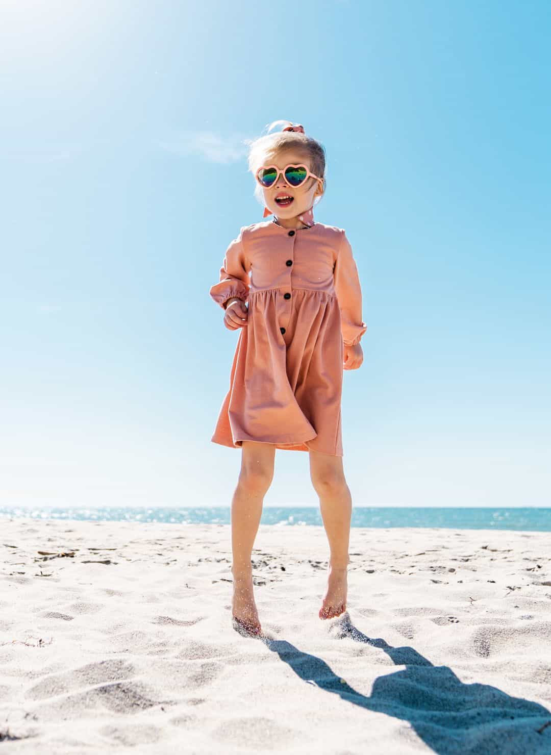 Child wearing CANDY jewellery on a sunny day at the beach