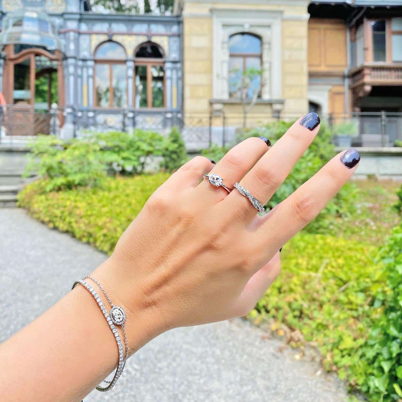 Frau trägt feine Armbänder und Ringe aus Silber 925 zusammen vor Villa Patumbah in Zürich 